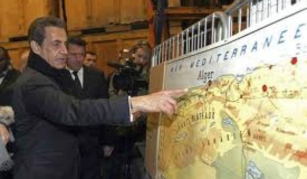 Nicolas Sarkozy pointant le doigt sur une carte de l'Algérie.